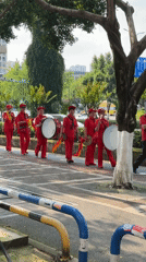 Women in red perform percussion parade in Chongqing