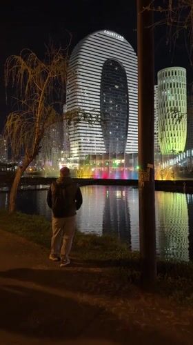 Evening waterfront observation in Batumi, Georgia draws solitary witness