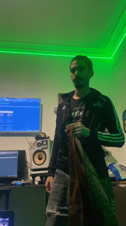 Young musicians work in green-lit Buenos Aires recording studio