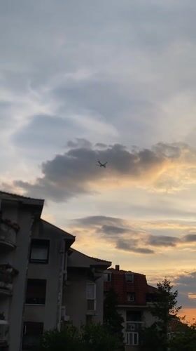 Aircraft filmed passing over Belgrade suburb during sunset