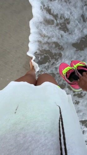 Barefoot evening beach walk captured in Jimbaran, Indonesia