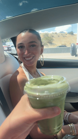 Woman receives green drink in car, Thousand Palms