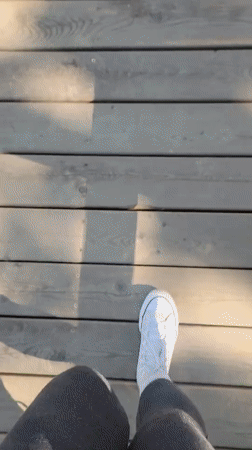 Hikers traverse coastal boardwalks and trails under cloudy skies