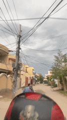Street food vendor operates mobile cart in Multan residential area