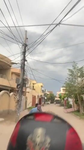 Street food vendor operates mobile cart in Multan residential area