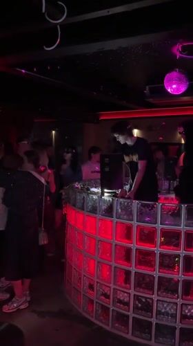 DJ performs for dancing crowd at Bangkok nightclub