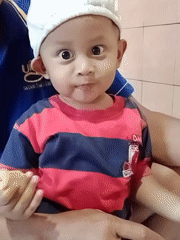 Toddler snack time and street food cart at an Indonesian market morning