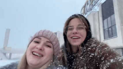 Heavy snowfall captured with smiling women in Ust-Ilimsk