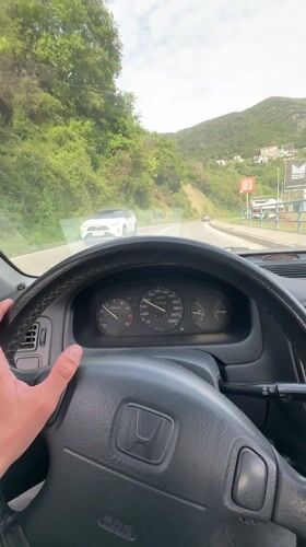 Driver navigates Honda Civic through Montenegro mountain roads