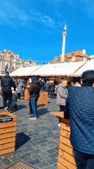 Crowds gather at Prague's Old Town Square on sunny afternoon