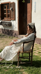 Woman works with rope outdoors in Serbian village