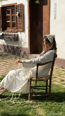 Woman works with rope outdoors in Serbian village
