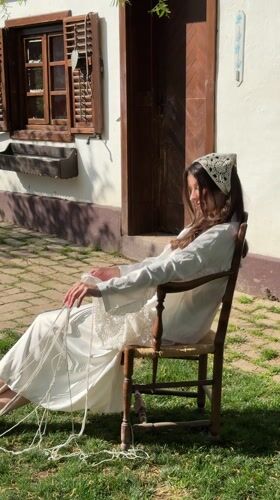 Woman works with rope outdoors in Serbian village