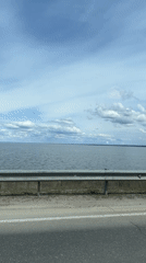 Vehicle travels waterfront road in Chaikovsky, Russia