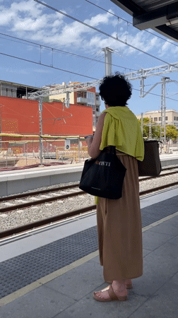 Regional train arrives at Castelldefels station, midday