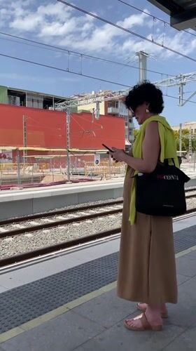 Regional train arrives at Castelldefels station, midday