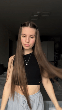 Woman takes mirror selfies in bedroom in Klin, Russia