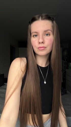 Woman takes mirror selfies in bedroom in Klin, Russia