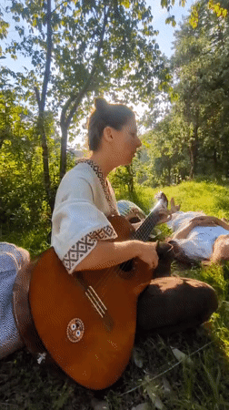 Woman performs acoustic music outdoors in Haini, India