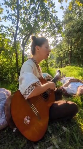 Woman performs acoustic music outdoors in Haini, India