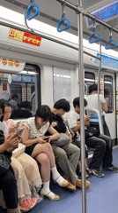 Child sleeps on passenger's lap in Jiulongpo subway car