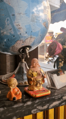 Table arrangement with globe, Buddha figurines captured in Amritsar