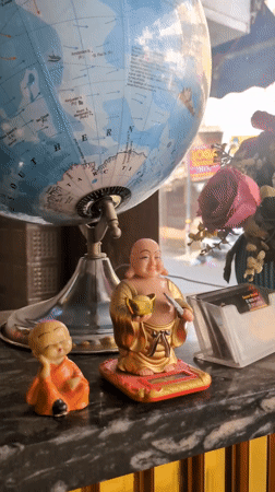 Table arrangement with globe, Buddha figurines captured in Amritsar