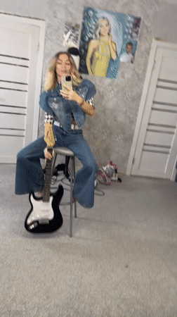 Woman films guitar content in Abakan indoor session
