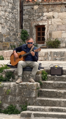 Street performers entertain tourists in historic Budva, Montenegro