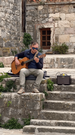 Street performers entertain tourists in historic Budva, Montenegro