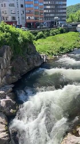 Urban river cascades through Gabrovo, Bulgaria creating natural waterfalls