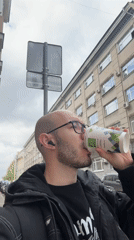 Man with glasses filmed on Moscow street during overcast morning