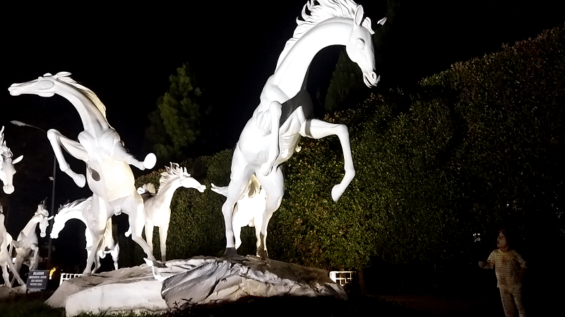 Illuminated white horse sculpture installation draws crowds in Semarang