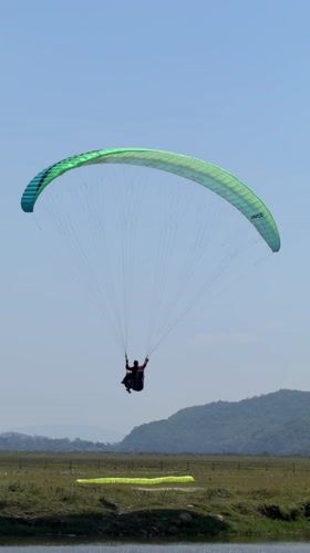 Morning paragliding and recreation activities documented near Pokhara lake