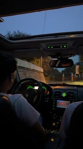 Backseat view riding through Angera in a Maserati