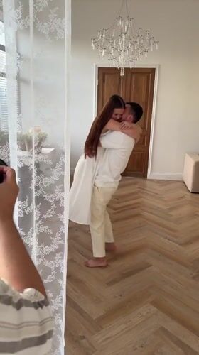 Couple in white dances and embraces in Izhevsk interior