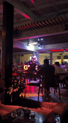 Red-dressed performer entertains diners at Nha Trang restaurant-cafe