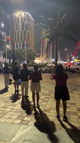 Evening dance gathering at Da Nang Beach boardwalk