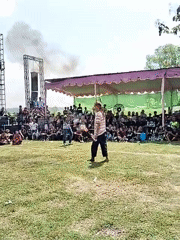 Fire breather performs for crowd in field