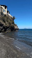 Tourist documents volcanic beaches and coastal life in Lipari