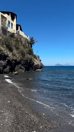 Tourist documents volcanic beaches and coastal life in Lipari