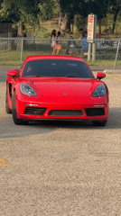 Red Porsche Cayman parked in Lake Delton lot