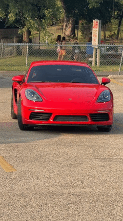 Red Porsche Cayman parked in Lake Delton lot
