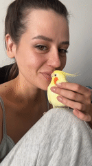 Woman bonds with pet cockatiel in Krasnoyarsk apartment