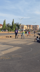 Children rollerblade on sunny Jos streets during afternoon recreation