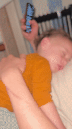 Child rests with family during quiet afternoon in Kiryat Bialik