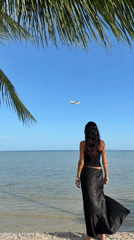Quiet Ko Samui coastline: beach, boat, and a passing plane