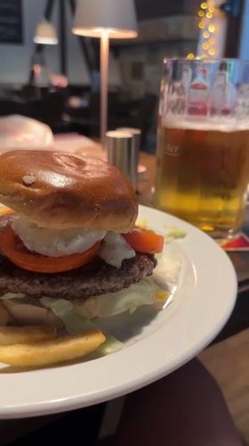 Lunch items documented at Kiel restaurant including burger, Currywurst