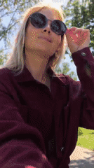 Woman photographs herself while strolling with baby in Sterlitamak park