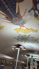 Subway station ceiling features colorful dragon mosaic artwork